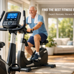 ​A senior man exercising on a modern upright stationary bike in a sunlit home living room. The foreground focuses on the bike's large digital console displaying fitness metrics like time, speed and heart rate. Text overlay reads "Find the Best Fitness Equipment - Expert Reviews. Honest Advice."